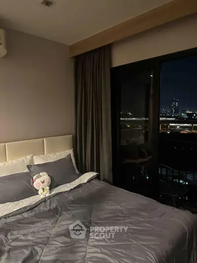 Cozy bedroom with city view, featuring plush bedding and elegant curtains for a serene ambiance.