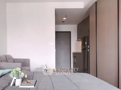 Modern studio apartment with cozy living area and compact kitchen