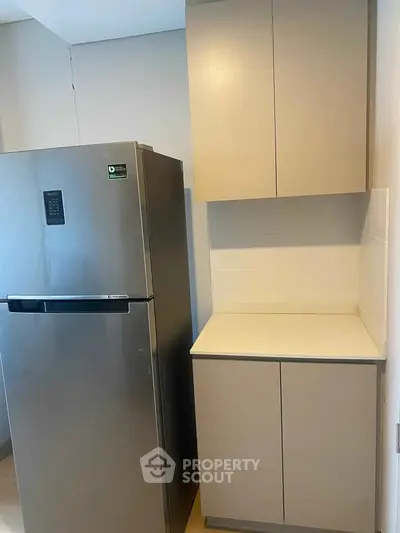Modern kitchen with sleek fridge and ample storage cabinets