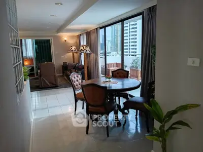 Spacious living and dining area with large windows and city view, perfect for urban living.