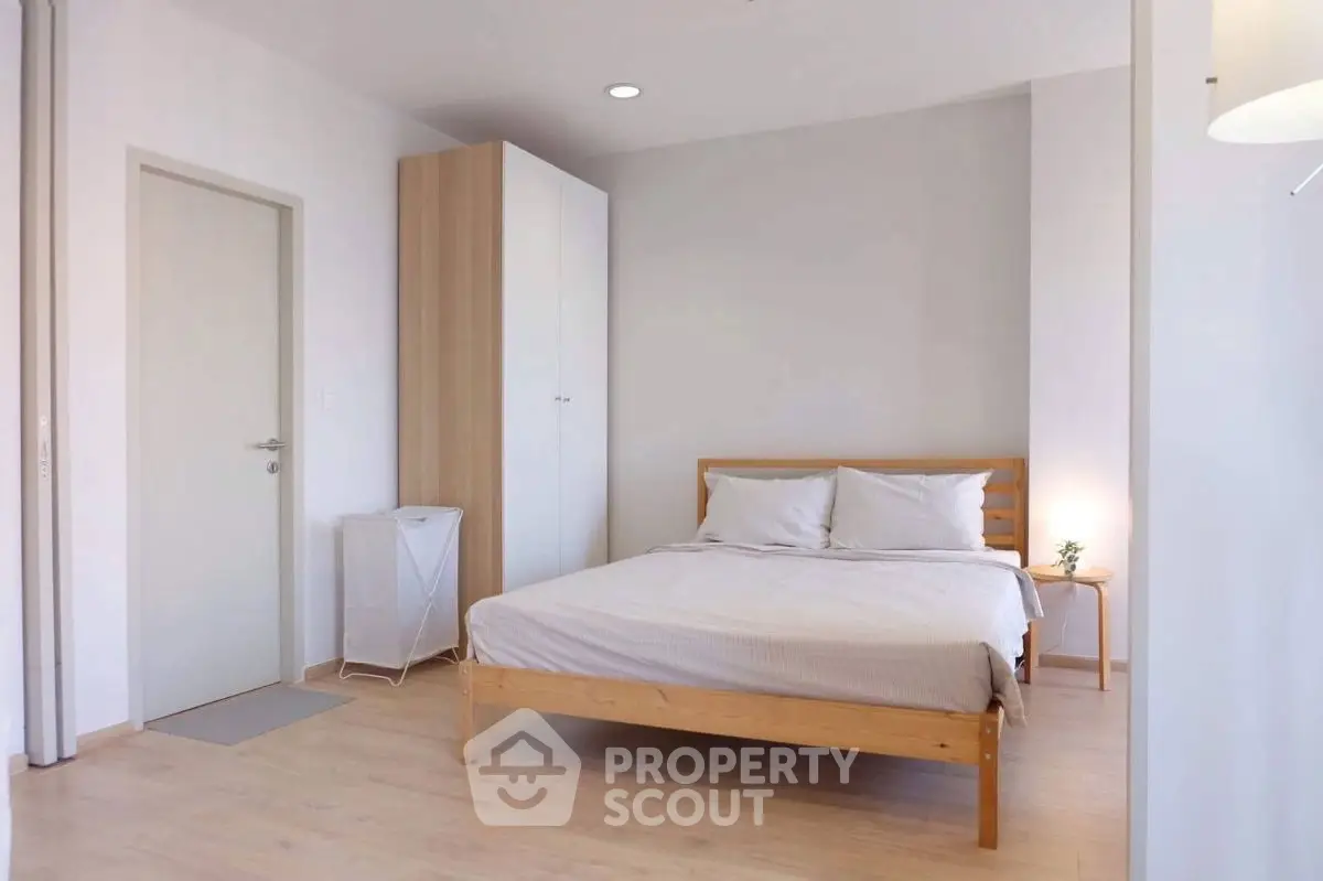 Spacious minimalist bedroom with wooden bed and modern decor