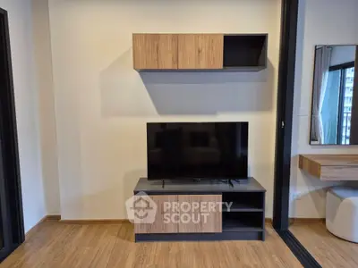 Modern living room with sleek TV stand and wall-mounted cabinet