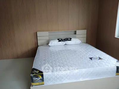 Modern bedroom with new mattress and wooden accent wall