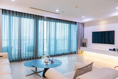 Spacious modern living room with large windows and elegant decor