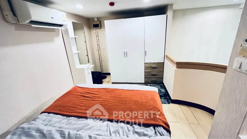 Cozy bedroom with modern furnishings and air conditioning in a stylish apartment.