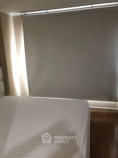 Cozy bedroom with minimalist design and large window shade