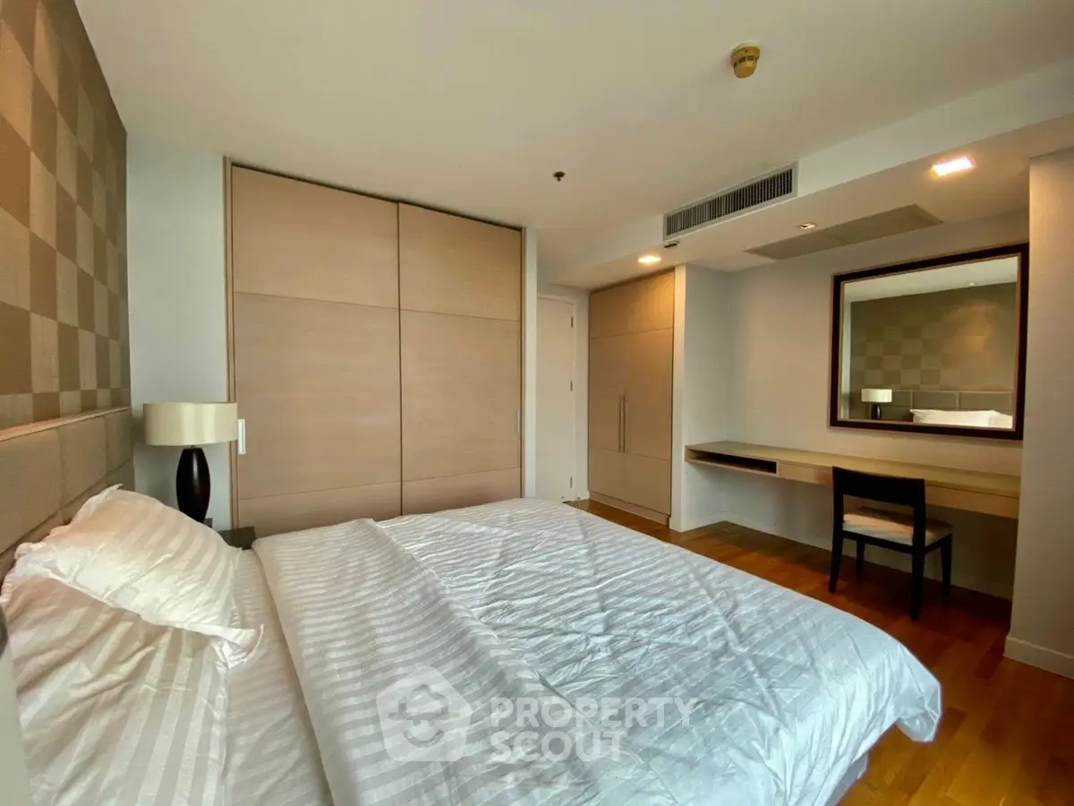 Spacious bedroom with modern decor and ample natural light