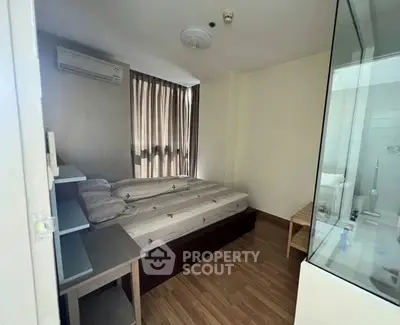 Cozy bedroom with wooden flooring and natural light