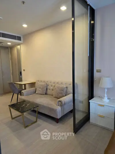 Modern living room with elegant sofa and stylish decor in a cozy apartment setting.