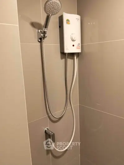 Modern bathroom with sleek shower unit and neutral tile design.