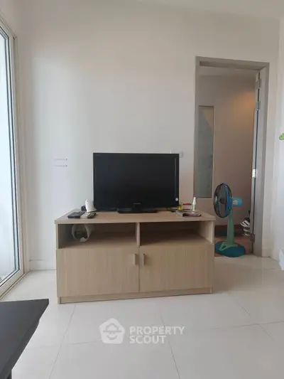 Modern living room with sleek TV stand and minimalist decor, perfect for urban living.
