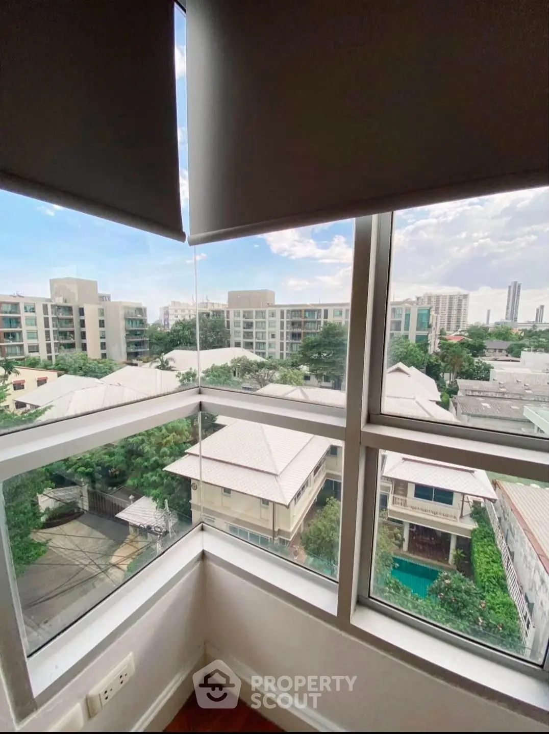 Stunning corner unit with panoramic city views from high-rise window, perfect for urban living.