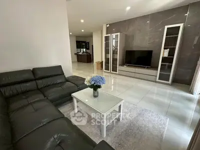 Spacious modern living room with sleek leather sofa and elegant decor