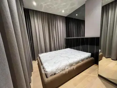 Modern bedroom with elegant curtains and stylish mirror accents