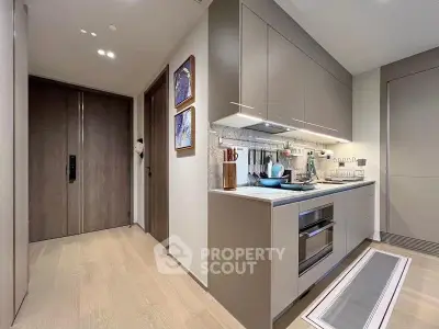 Modern kitchen with sleek cabinetry and built-in appliances in a stylish apartment.