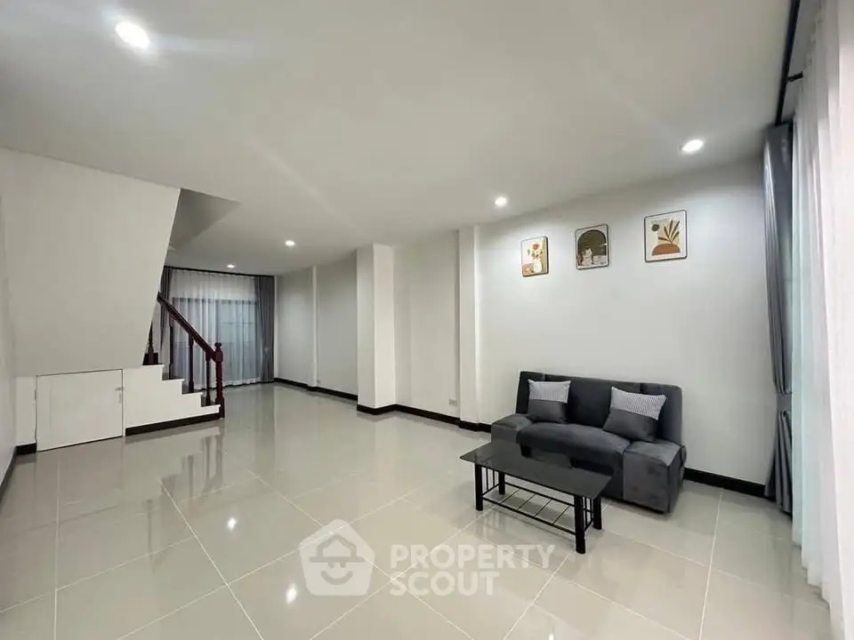 Spacious modern living room with sleek tile flooring and stylish decor