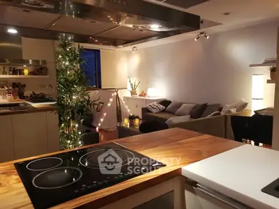 Modern open-plan kitchen and living room with cozy lighting and stylish decor.