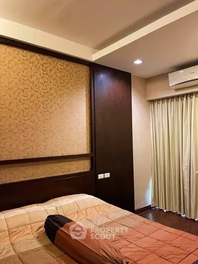 Cozy bedroom with elegant wallpaper and air conditioning unit