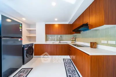 Modern kitchen with sleek wooden cabinets and built-in appliances