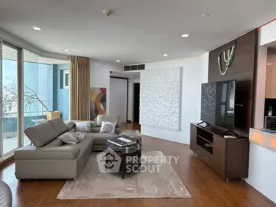 Luxurious modern living room with sleek furniture and large windows offering stunning views.