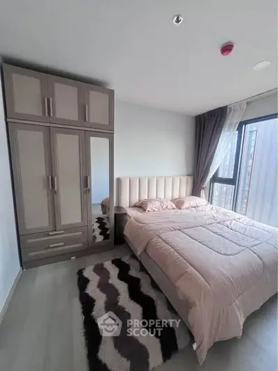 Modern bedroom with stylish wardrobe and cozy bed in a bright apartment