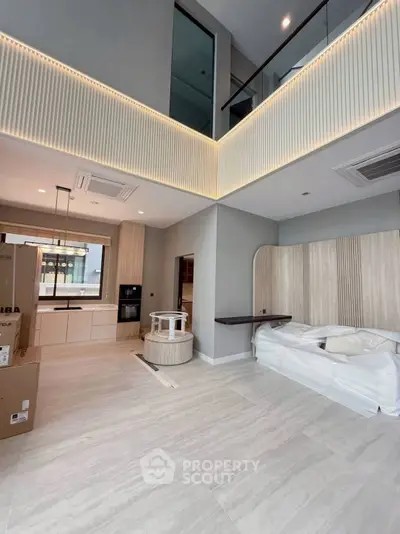 Modern open-plan living room with high ceilings and stylish decor