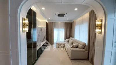 Luxurious living room with elegant archway, plush sofa, and ambient lighting