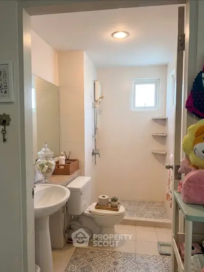 Charming bathroom with modern shower and stylish decor, perfect for a cozy home.
