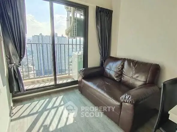 Cozy living room with leather sofa and balcony view in modern apartment
