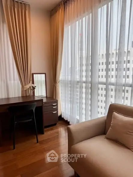 Elegant corner unit with floor-to-ceiling windows and cozy seating area, perfect for relaxation.