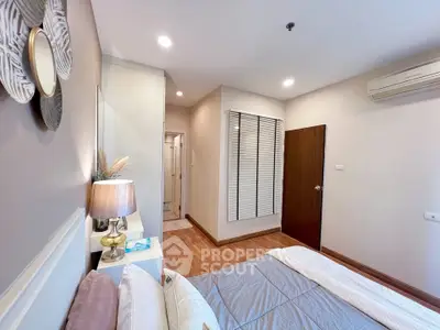 Cozy bedroom with modern decor and air conditioning in a stylish apartment.
