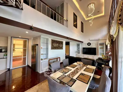 Luxurious open-plan living and dining area with high ceilings and elegant decor