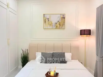 Elegant bedroom with modern decor and cozy lighting, perfect for relaxation.