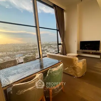 Luxurious high-rise living room with panoramic city views and elegant furnishings.