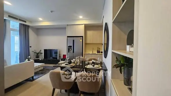 Modern open-plan living room and kitchen with elegant dining area and stylish decor.