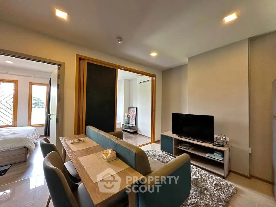 Modern living room with dining area and bedroom view in open layout apartment