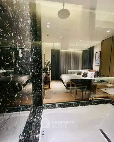 Luxurious bedroom with elegant decor and marble accents, featuring a cozy bed and stylish furnishings.