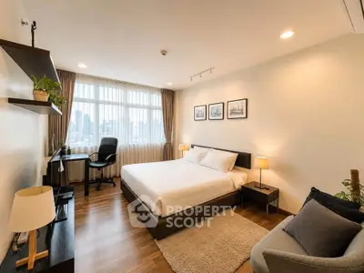 Spacious modern bedroom with city view, featuring elegant decor and ample natural light.