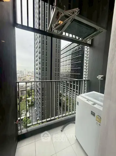 Modern high-rise balcony with city view and washing machine setup.