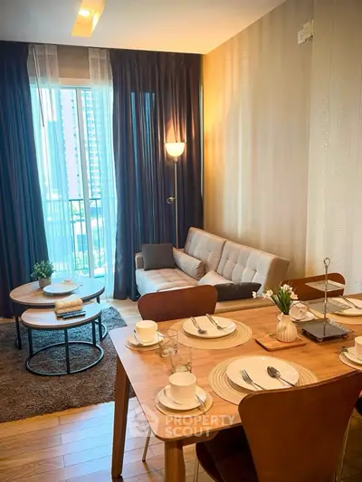 Stylish living room with modern decor and dining area in a high-rise apartment.