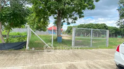 Charming property with lush greenery and secure fencing, ideal for development or investment.