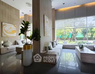 Luxurious modern living room with large windows and stylish decor in a high-end property.