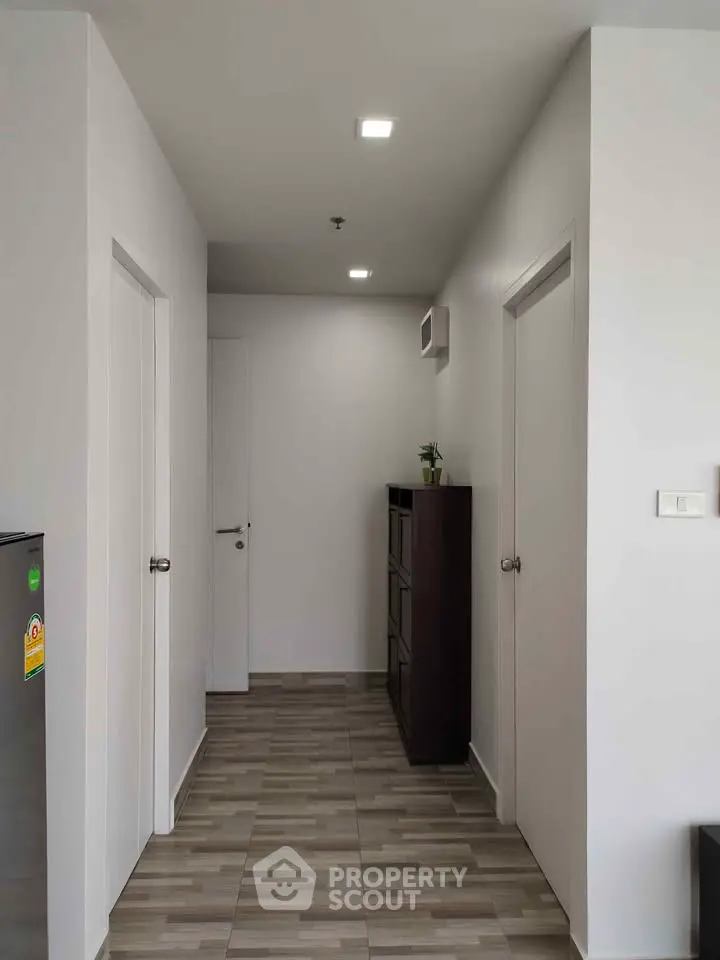 Modern hallway with sleek design and neutral tones, featuring stylish flooring and minimalist decor.
