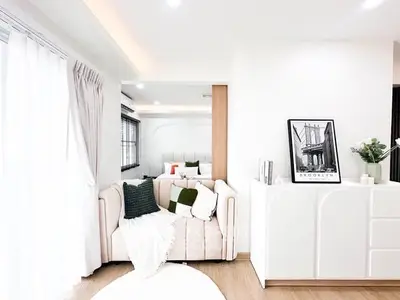 Bright and modern living room with cozy sofa and stylish decor