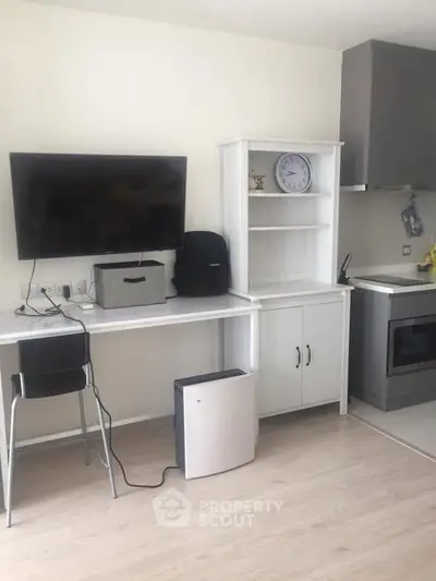 Modern kitchen with sleek appliances and stylish shelving in a compact layout.