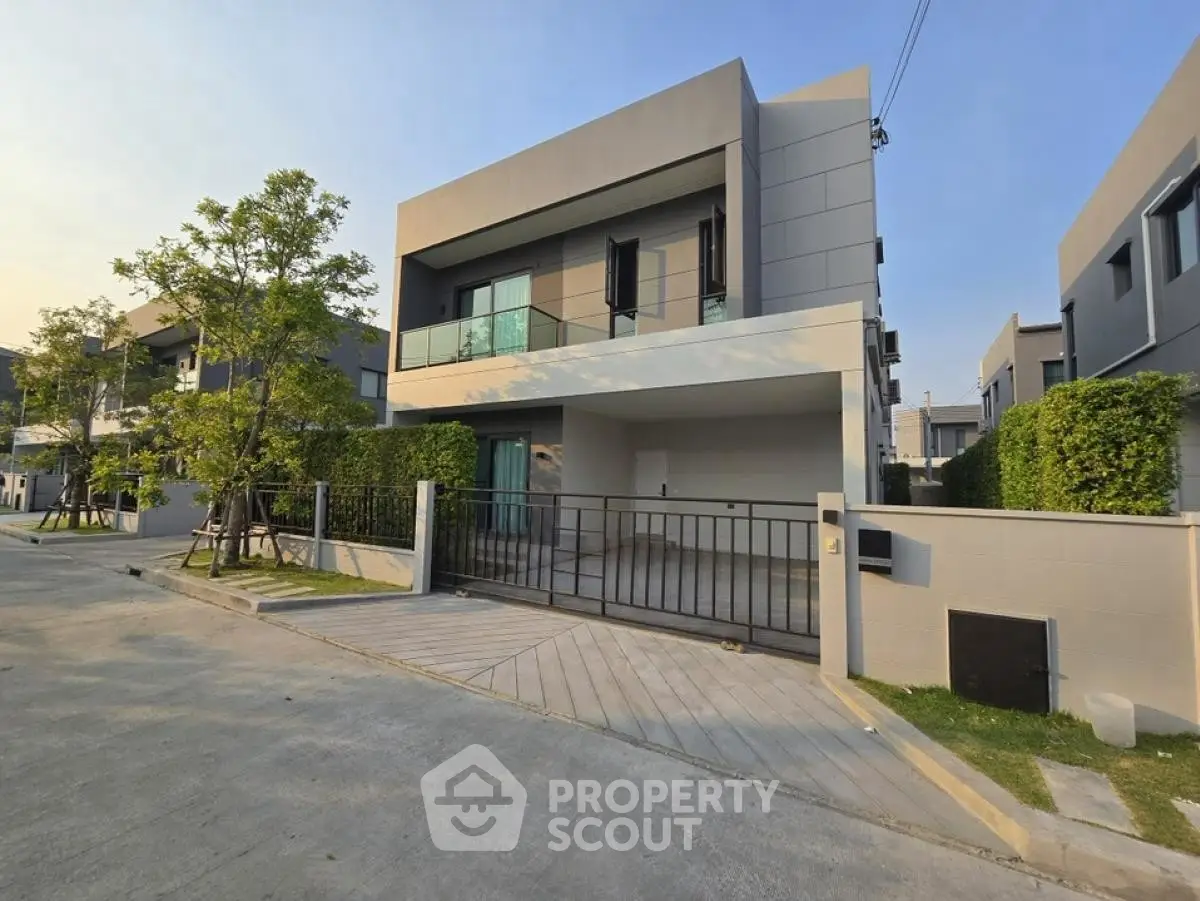 Modern two-story house with sleek design and spacious driveway in a serene neighborhood.