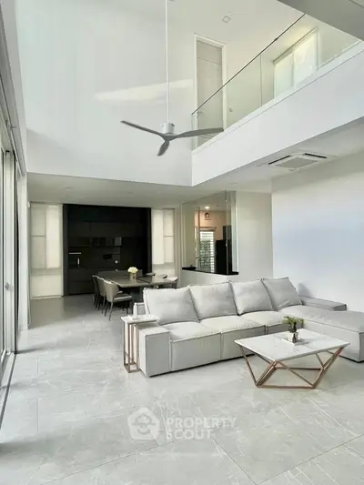 Spacious modern living room with high ceiling and elegant decor