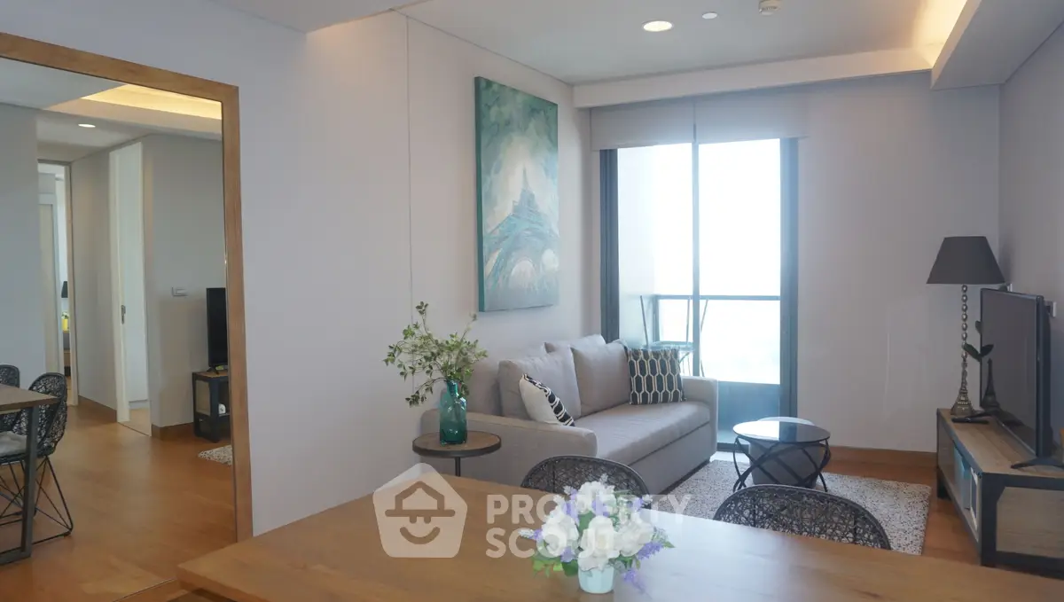 Modern living room with stylish decor and large window offering natural light