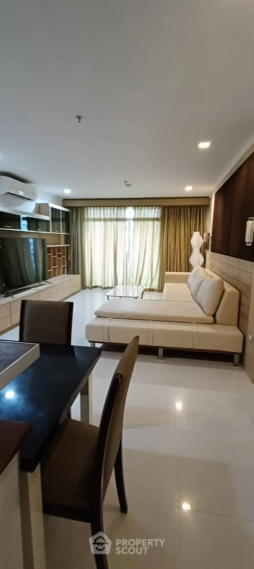 Spacious living room with modern furniture and large windows