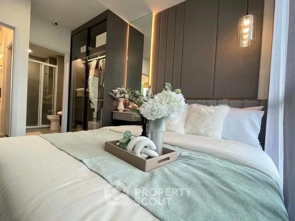 Luxurious bedroom with elegant decor and soft lighting, featuring a cozy bed and modern ensuite bathroom.